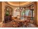 Dining room with a round wooden table, decorative chandelier, and unique decorative ceiling at 41731 N Stone Cutter Dr, Scottsdale, AZ 85262