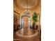 Elegant foyer featuring decorative tile floor, chandelier and front door with iron detailing at 41731 N Stone Cutter Dr, Scottsdale, AZ 85262