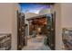 Exterior front entrance with decorative wrought iron gates and desert landscape at 41731 N Stone Cutter Dr, Scottsdale, AZ 85262