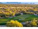 Scenic view of lush golf course and surrounding desert landscape with mountain views in the background at 41731 N Stone Cutter Dr, Scottsdale, AZ 85262