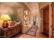 Hallway with art niches, wood door and Saltillo tile flooring at 41731 N Stone Cutter Dr, Scottsdale, AZ 85262