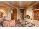 Cozy living room with fireplace and terracotta tile flooring, enhanced by stucco walls at 41731 N Stone Cutter Dr, Scottsdale, AZ 85262