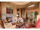 Spacious living room featuring fireplace, comfortable seating and stone-tiled floor at 41731 N Stone Cutter Dr, Scottsdale, AZ 85262