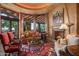 Cozy living room featuring a fireplace, ample seating, and large windows providing abundant natural light at 41731 N Stone Cutter Dr, Scottsdale, AZ 85262