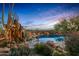 Inviting pool area with a sculpture, rocks, and desert landscaping, creating a serene and picturesque outdoor oasis at 41731 N Stone Cutter Dr, Scottsdale, AZ 85262