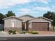 Charming single-story home features stone accents, a two-car garage, and professionally landscaped front yard at 4281 W Hannah St, San Tan Valley, AZ 85144