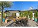 Outdoor dining area featuring modern furniture, gravel landscaping, mature trees, and a covered patio at 4595 E Calle Redonda --, Phoenix, AZ 85018