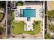 Aerial view of a backyard featuring a pool, lounge chairs, manicured lawn, and a cozy firepit area at 5139 S Bridal Vail Dr, Gilbert, AZ 85298