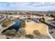 Aerial view of a community with a pond, walking trails, picnic pavilions, and lush greenery at 5139 S Bridal Vail Dr, Gilbert, AZ 85298