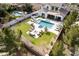 Aerial view of a spacious backyard with pool, lounge area, and a cozy outdoor seating area with firepit at 5139 S Bridal Vail Dr, Gilbert, AZ 85298