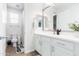 Clean and modern bathroom featuring white cabinetry, a toilet and a shower/tub combo at 5139 S Bridal Vail Dr, Gilbert, AZ 85298