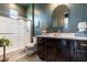 Stylish bathroom featuring a glass-enclosed shower, dark wood cabinets, and decorative accents at 5139 S Bridal Vail Dr, Gilbert, AZ 85298