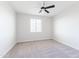 Bright bedroom with neutral carpet, ceiling fan, and a window offering natural light at 5139 S Bridal Vail Dr, Gilbert, AZ 85298