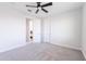 Spacious bedroom with neutral carpet, ceiling fan, and view to another room at 5139 S Bridal Vail Dr, Gilbert, AZ 85298