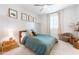 Cozy bedroom with white walls, paneled accent wall, wooden bedframe, and a comfy reading chair at 5139 S Bridal Vail Dr, Gilbert, AZ 85298