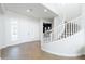 Elegant entryway with a curved staircase, bright natural light, and neutral decor at 5139 S Bridal Vail Dr, Gilbert, AZ 85298