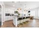 Bright, white kitchen with a large island, pendant lighting, and modern appliances at 5139 S Bridal Vail Dr, Gilbert, AZ 85298