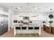 Stylish kitchen featuring a large island with seating, stainless steel appliances, and white cabinets at 5139 S Bridal Vail Dr, Gilbert, AZ 85298