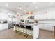 Elegant kitchen with a spacious island, bar stools, and stainless steel refrigerator at 5139 S Bridal Vail Dr, Gilbert, AZ 85298