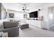 Inviting living room featuring a large gray couch, television, and athletic memorabilia at 5139 S Bridal Vail Dr, Gilbert, AZ 85298