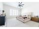 Bright main bedroom featuring a ceiling fan, white walls, and carpeted floor at 5139 S Bridal Vail Dr, Gilbert, AZ 85298