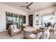 Covered patio with travertine tile, ceiling fan and outdoor dining next to the pool at 5139 S Bridal Vail Dr, Gilbert, AZ 85298