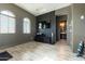 Modern recreation room featuring laminated floors, accent wall, TV and weights at 5139 S Bridal Vail Dr, Gilbert, AZ 85298