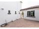 View of a landscaped side yard with pavers, an iron gate, and white exterior walls at 5139 S Bridal Vail Dr, Gilbert, AZ 85298