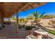 Beautiful backyard area with a stone patio, pond, and lush landscaping at 5161 N Scottsdale Rd, Eloy, AZ 85131