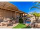 Covered patio with outdoor seating and a charming water feature in the lush backyard at 5161 N Scottsdale Rd, Eloy, AZ 85131