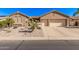 Charming single-story home showcasing desert landscaping, a two-car garage, and a tiled roof at 5161 N Scottsdale Rd, Eloy, AZ 85131