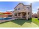 Spacious backyard features a pool, putting green, and covered patio with outdoor kitchen at 5356 W Jupiter Way, Chandler, AZ 85226