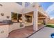 Outdoor kitchen featuring a built-in grill area on a patterned concrete surface, with stucco walls at 5356 W Jupiter Way, Chandler, AZ 85226