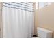 Bright bathroom featuring a toilet and a white shower curtain with blue trim at 5356 W Jupiter Way, Chandler, AZ 85226