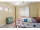 Bright bedroom with a colorful quilt, windows, and a ceiling fan at 5356 W Jupiter Way, Chandler, AZ 85226