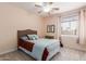 Comfortable bedroom with plush carpet, a ceiling fan, and a large window with natural light at 5356 W Jupiter Way, Chandler, AZ 85226