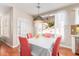 Bright dining room featuring a pendant light, wooden floor, and a dining table set for a meal at 5356 W Jupiter Way, Chandler, AZ 85226