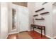 Inviting entryway with hardwood floors, console table, decorative shelving, and natural light at 5356 W Jupiter Way, Chandler, AZ 85226