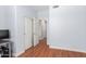 Hallway with hardwood floors leading to adjacent rooms, including one with an open closet at 5356 W Jupiter Way, Chandler, AZ 85226