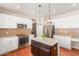 Bright kitchen featuring an island, stainless steel appliances, a mosaic backsplash, and ample counter space at 5356 W Jupiter Way, Chandler, AZ 85226