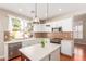 Modern kitchen with stainless steel appliances, island, mosaic backsplash, and ample cabinet space at 5356 W Jupiter Way, Chandler, AZ 85226