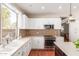 Bright kitchen with white cabinets, neutral countertops and stainless steel appliances at 5356 W Jupiter Way, Chandler, AZ 85226