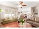 Open concept living room featuring tile flooring, large windows, and comfortable seating with an open kitchen view at 5356 W Jupiter Way, Chandler, AZ 85226