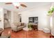 Cozy living room featuring hardwood floors, entertainment center and easy access to staircase at 5356 W Jupiter Way, Chandler, AZ 85226