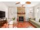 Comfortable living room with a stone accent wall, fireplace, and hardwood floors at 5356 W Jupiter Way, Chandler, AZ 85226