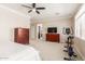 Spacious bedroom boasting carpet, a ceiling fan, and exercise equipment by the window at 5356 W Jupiter Way, Chandler, AZ 85226