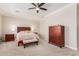 Relaxing main bedroom featuring a ceiling fan, carpeted floor, and wooden furniture at 5356 W Jupiter Way, Chandler, AZ 85226