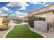 Expansive backyard featuring a well-maintained lawn, patio area, and vibrant blooming bushes, perfect for relaxation at 5539 S Verde --, Mesa, AZ 85212