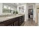 Elegant bathroom with dual sinks, granite countertops, dark wood cabinetry, and a walk-in closet at 5539 S Verde --, Mesa, AZ 85212