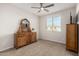 Neutral bedroom features a ceiling fan, carpet, a window, and vintage wood furniture at 5539 S Verde --, Mesa, AZ 85212